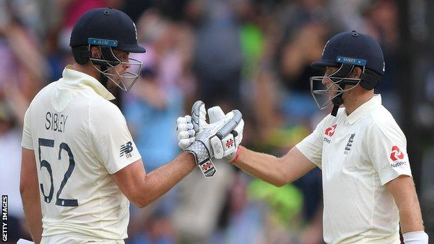 England batsman Dom Sibley (left) is congratulated by Joe Root (right) after reaching his maiden Test fifty against South Africa