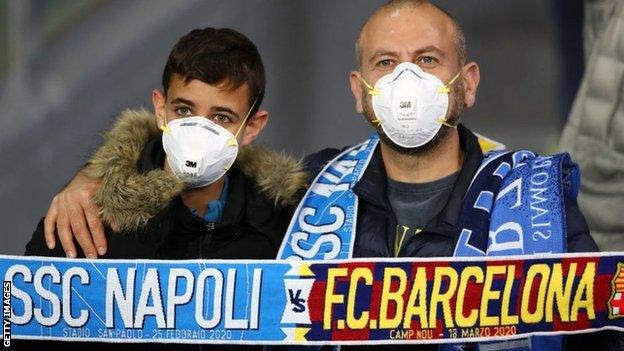 Fans at the Napoli v Barcelona Champions League game wearing face masks