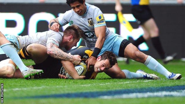 Wasps' Rob Miller is held up by Northampton's defence just before the line