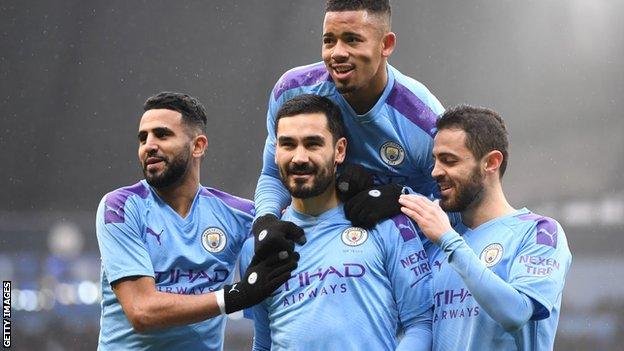 Ilkay Gundogan, centre, celebrates with Man City team-mates