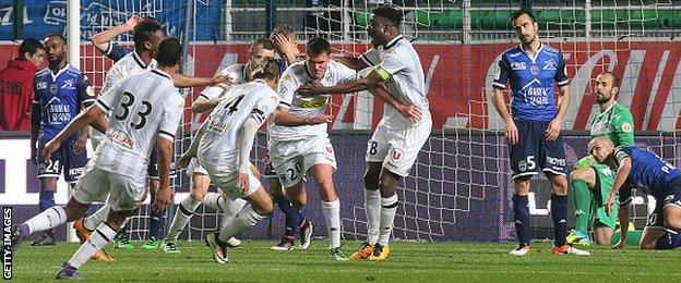 The players of Angers celebrate Charles Diers' winning goal which confirmed Troyes' relegation from Ligue 1