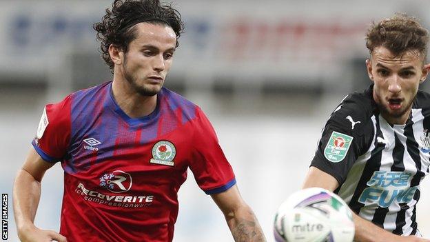 Lewis Travis challenges Newcastle midfielder Daniel Barlaser during their Carabao Cup tie