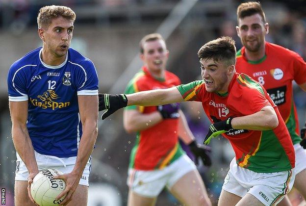 Cavan's Killian Clarke comes under pressure from Donal Smithers of Carlow