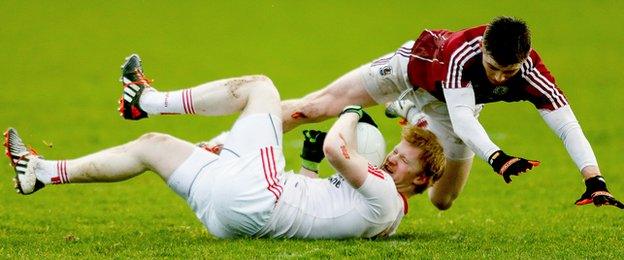 Tyrone substitute Hugh Pat McGeary and Galway's Daithi Gaoithin take a tumble during the Division Two clash