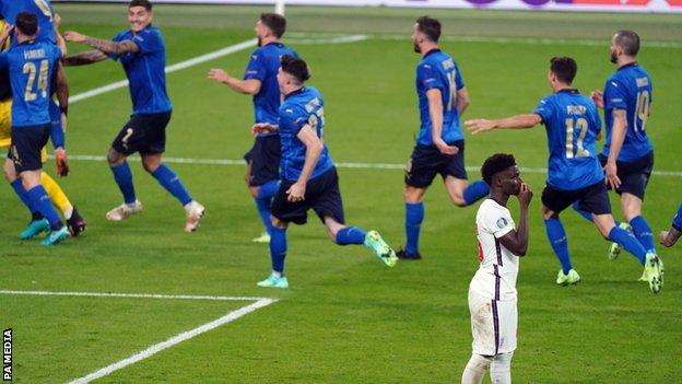 Bukayo Saka after his penalty miss with Italy player celebrating