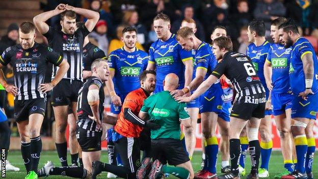 Referee Phil Bentham receives treatment after his collision with Chris Houston