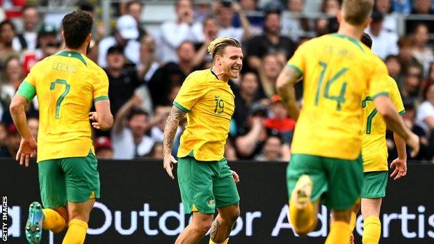 Australia striker Jason Cummings (centre) celebrates his goal