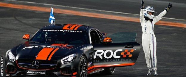 Susie Wolff waves to the crowd after losing to David Coulthard during the Race of Champions at the Olympic Stadium