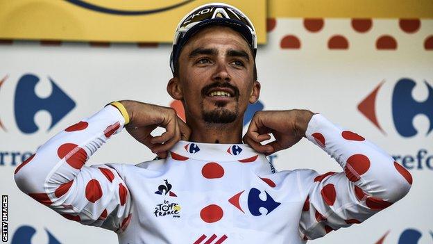 Julian Alaphilippe pulls on the polka dot jersey after winning stage 16