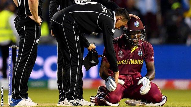 New Zealand's Ross Taylor (left) consoles West Indies' Carlos Brathwaite (right) after victory in the World Cup at Old Trafford