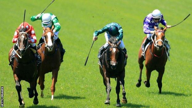 Jockeys using whips during a race