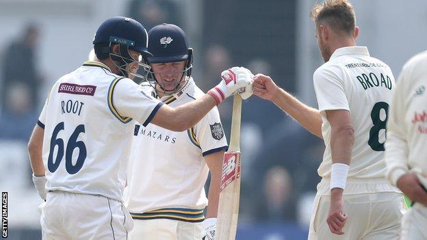 Joe Root bumps fists with Stuart Broad