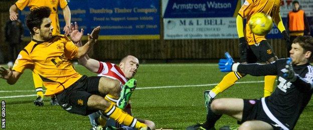 Rabin Omar slides in the fourth goal for Annan