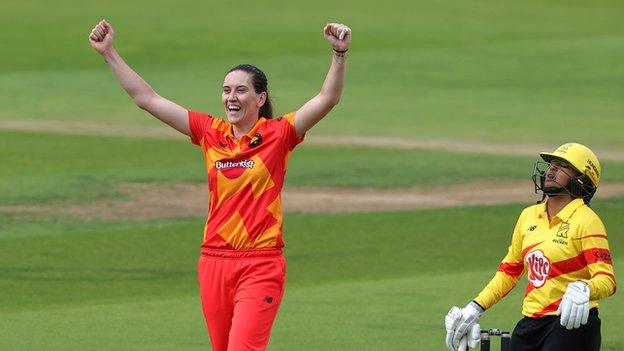 Emily Arlott (left) playing for Birmingham Phoenix celebrates the wicket of Alana King (right)