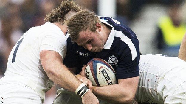 Scotland lock Jonny Gray is tackled by Joe Marler and Courtney Lawes against England