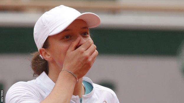 Iga Swiatek celebrates winning French Open title