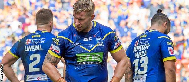 Mike Cooper (foreground) stands dejected after Warrington's Wembley defeat by Catalans