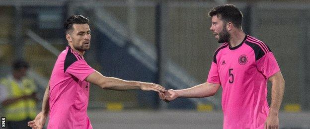 Russell Martin and Grant Hanley shake hands during Scotland's friendly defeat by Italy in May