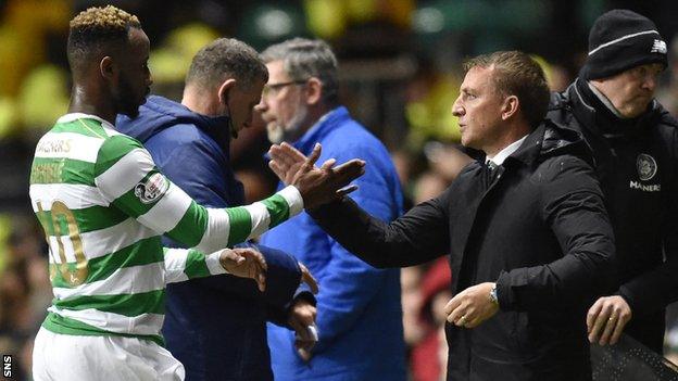 Moussa Dembele shakes hands with Brendan Rodgers