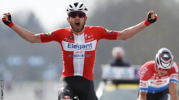 Denmark's Kasper Asgreen (left) raises his arms in celebration after beating Mathieu van der Poel (right) to win the 2021 Tour of Flanders