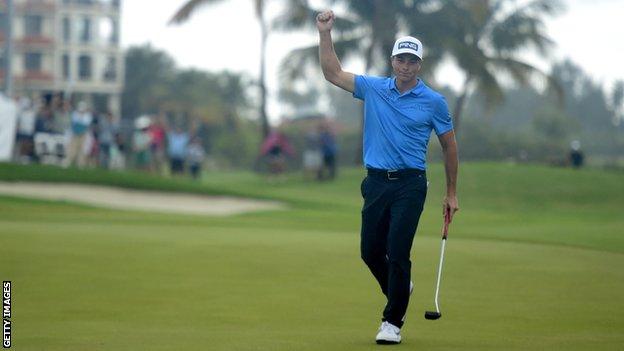 Viktor Hovland punches the air in celebration after hitting a birdie putt on the final hole to win the Puerto Rico Open trophy