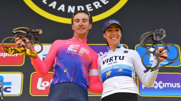 Italian riders Alberto Bettiol (left) and Marta Bastianelli (right) hold up their trophies after winning the men's and women's Tour of Flanders