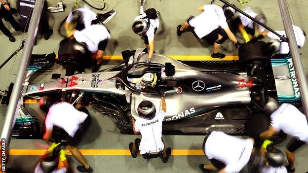 Mercedes mechanics work on Lewis Hamilton's car