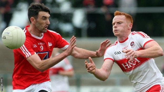 Louth's James Califf battles with Derry's Conor McAtamney at Owenbeg