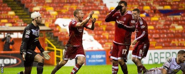 Aberdeen's Adam Rooney claims for a late penalty