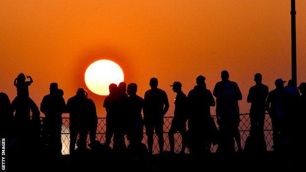 Fans watch the sun go down