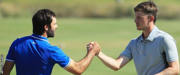 Joel Stalter of France congratulates Connor Syme on the 18th green