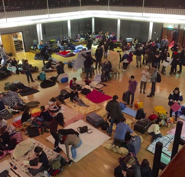 Students laying out bedding on the floor of the Great Hall in Lancaster University