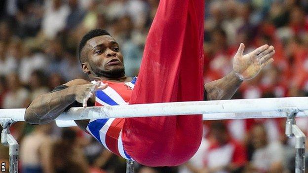 Courtney Tulloch from Britain performs on the parallel bars