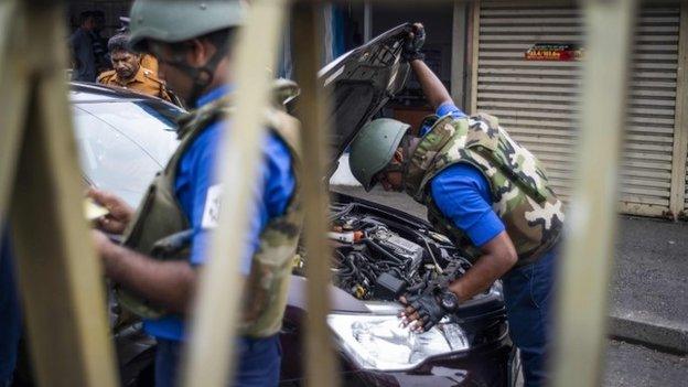 Sri Lankan soldiers inspect a car at a checkpoint in Colombo on April 27, 2019,