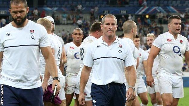 England head coach Stuart Lancaster (centre) leads his team off the field after defeat in Paris