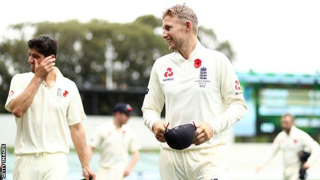 Alastair Cook and Joe Root celebrate a winning start for England during their Ashes Tour as they leave the Adelaide Oval pitch