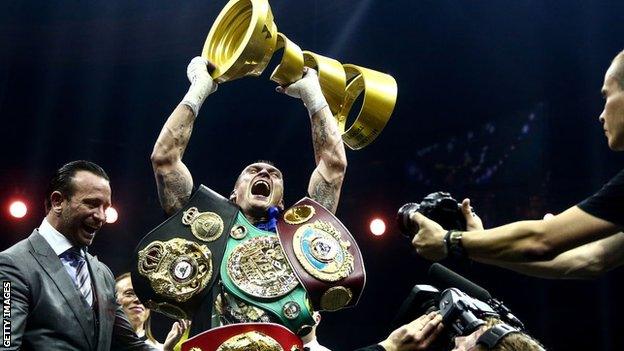 Usyk lifts his belts and the Muhammad Ali Trophy