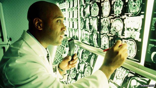 Doctor looks at brain scans