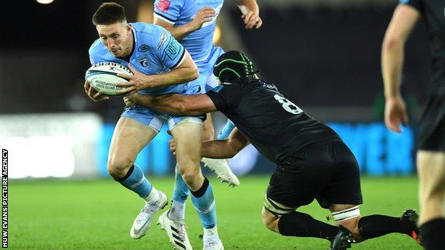 Cardiff wing Josh Adams is tackled by Ospreys number eight Morgan Morris in his first games of the 2020-21 season