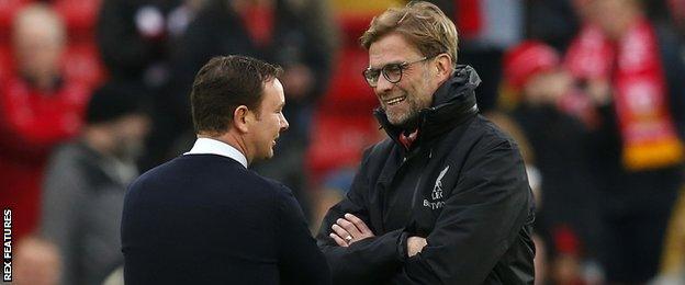 Derek Adams (left) in conversation with Liverpool boss Jurgen Klopp