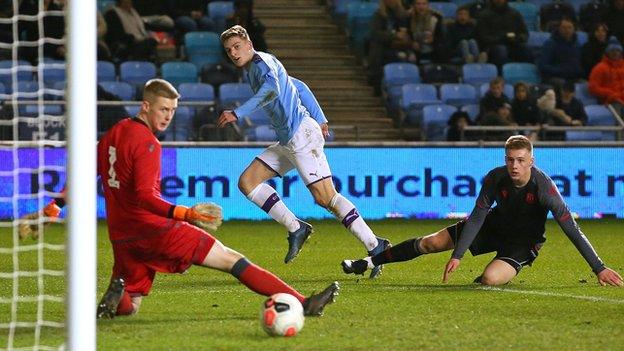 Liam Delap of Manchester City scores their second goal past Nathan Broome of Stoke City during the Premier League Cup Final