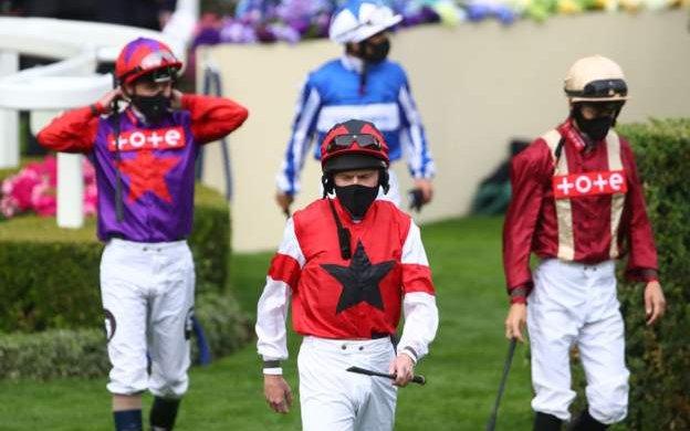 A day at the socially distanced races - jockeys come out for a race