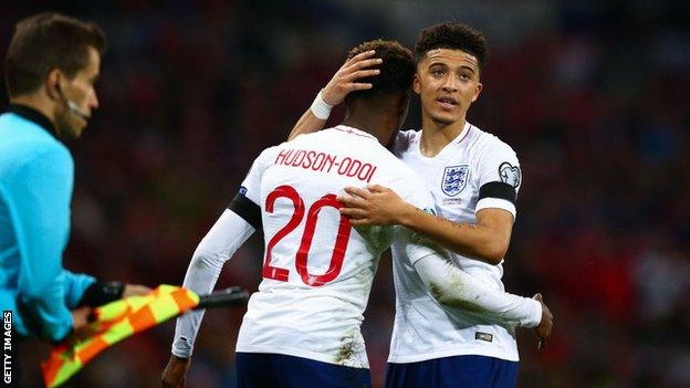 Callum Hudson-Odoi and Jadon Sancho embrace