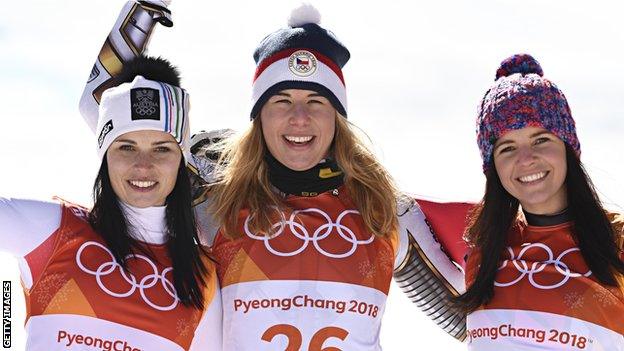 The winner's podium from the women's super G