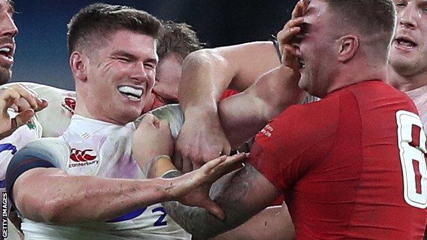 England's Owen Farrell tussles with Wales number eight Ross Moriarty