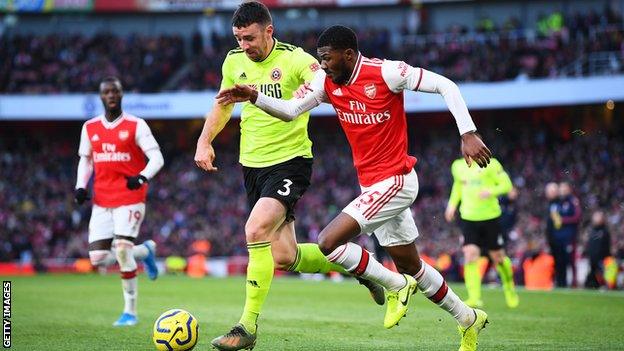 Enda Stevens holds off Arsenal's Ainsley Maitland-Niles