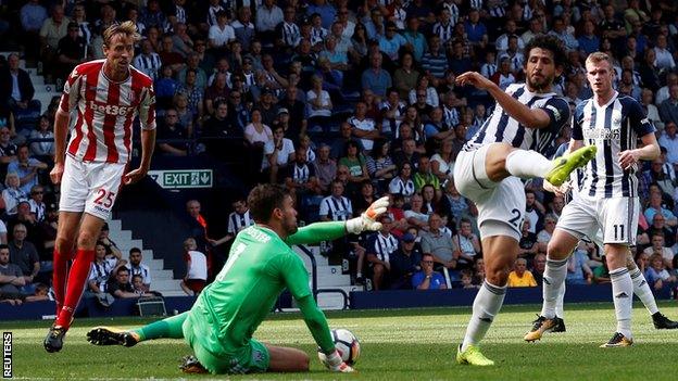 Ahmed Hegazi (right) and Ben Foster (centre) fail to clear