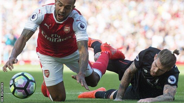 Alberto Moreno brings down Arsenal's Theo Walcott at the Emirates