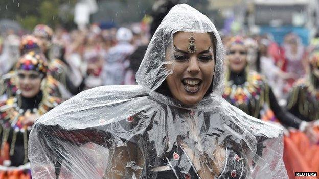 Performers dance in the rain