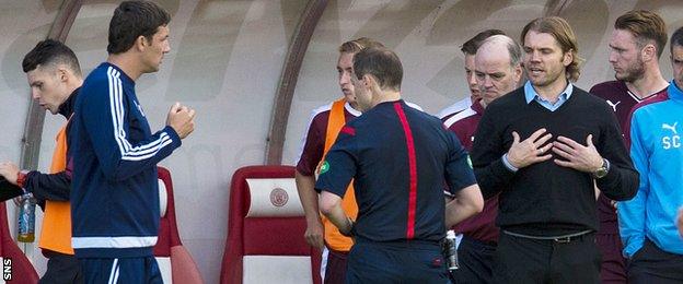 Robbie Neilson remonstrates with Collum in the dugout